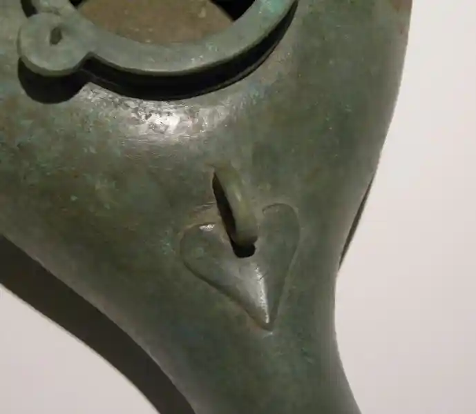 An incense burner with a heart engraved on it